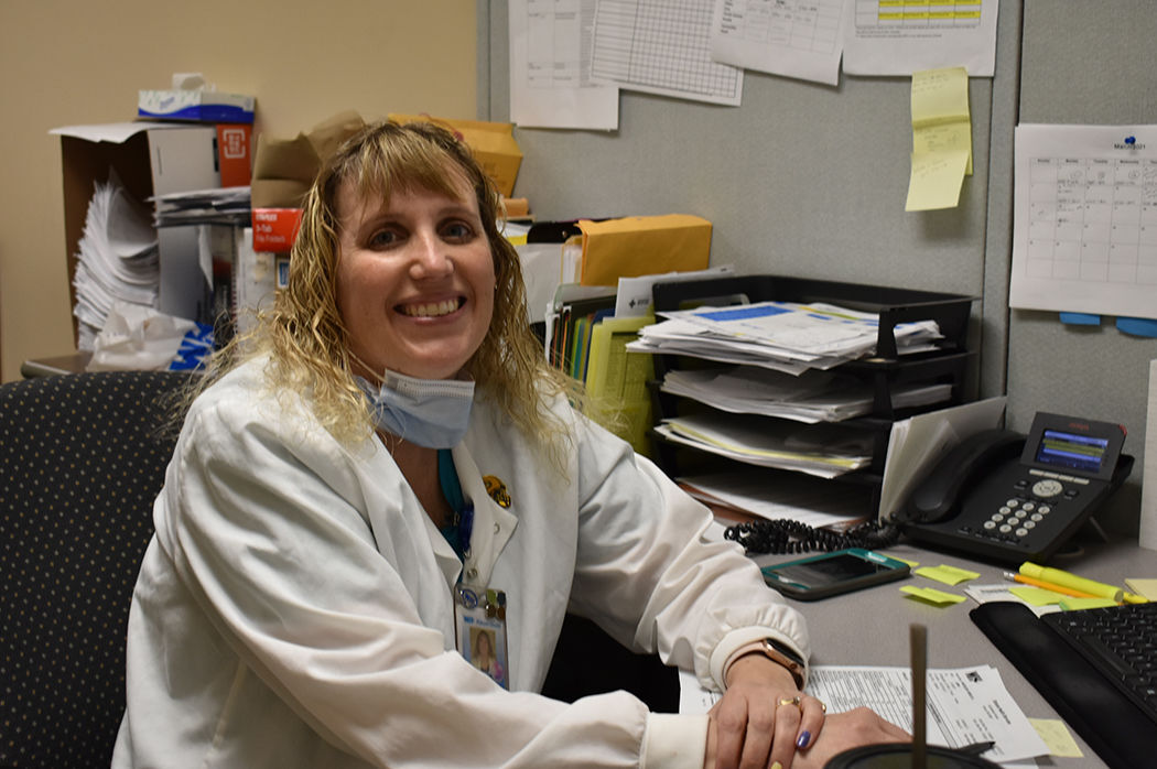 Anne Larson at desk